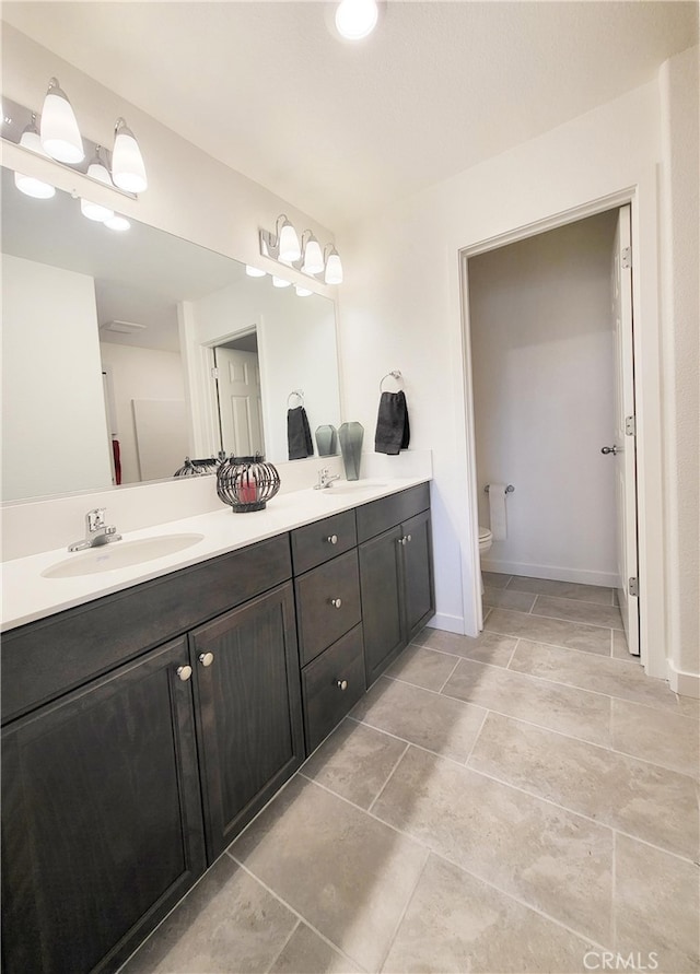 209 Dylan St, Merced, CA 95341 - bathroom featuring double vanity, toilet, and baseboards