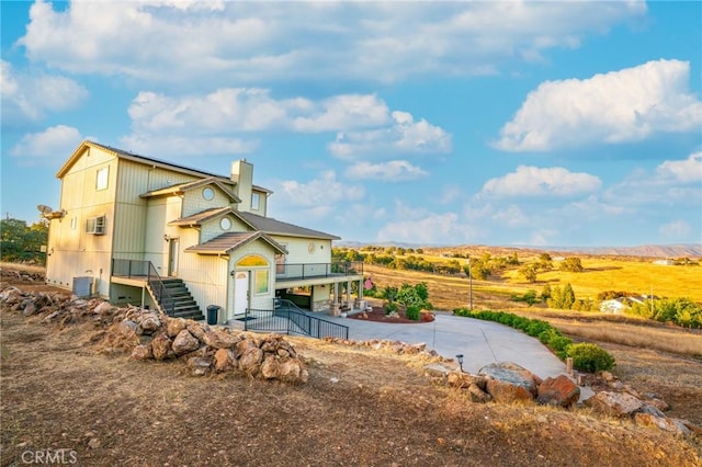 9713 Rastro Way, La Grange, CA 95329 - back of property featuring a chimney, stairway, and central AC