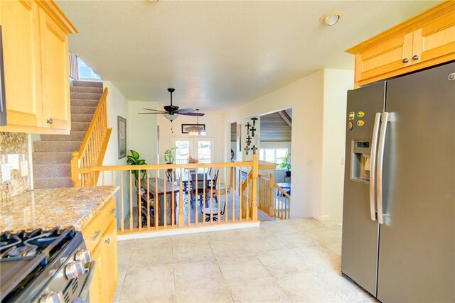 9713 Rastro Way, La Grange, CA 95329 - kitchen featuring appliances with stainless steel finishes, a ceiling fan, light brown cabinetry, backsplash, and light tile patterned flooring