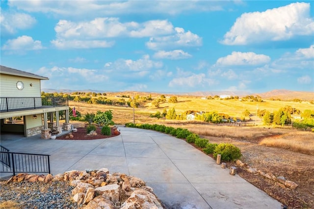 9713 Rastro Way, La Grange, CA 95329 - view of patio / terrace with curved driveway, a mountain view, and a view of rural / pastoral area