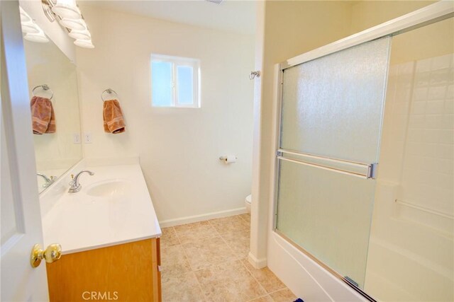 9713 Rastro Way, La Grange, CA 95329 - full bath with vanity, toilet, combined bath / shower with glass door, tile patterned flooring, and baseboards