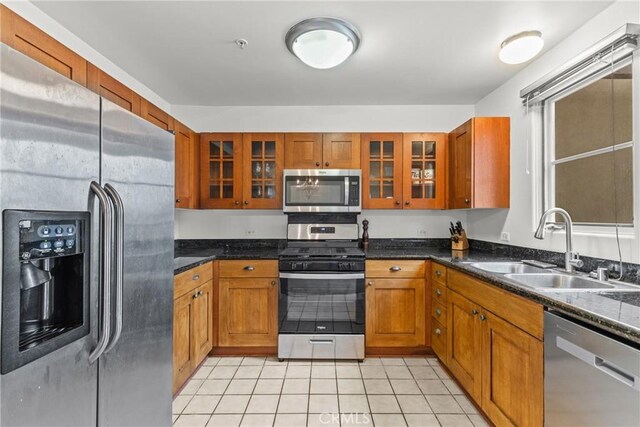 809 Meridian Ave Unit U, South Pasadena, CA 91030 - kitchen featuring appliances with stainless steel finishes, a sink, brown cabinetry, and glass insert cabinets