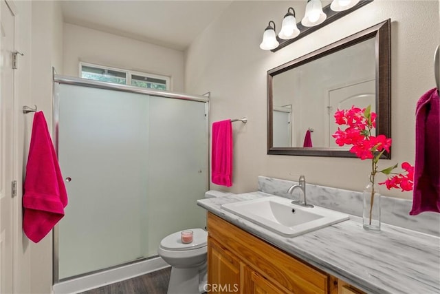 14868 Hickok Ct, Magalia, CA 95954 - full bath with vanity, toilet, a shower stall, and wood finished floors