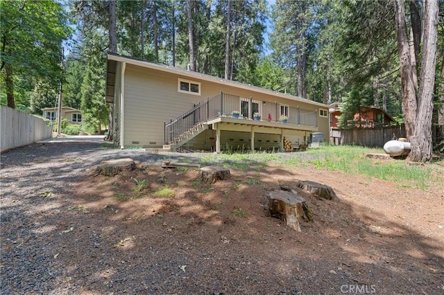 14868 Hickok Ct, Magalia, CA 95954 - rear view of house with crawl space, a wooden deck, stairway, and view of wooded area