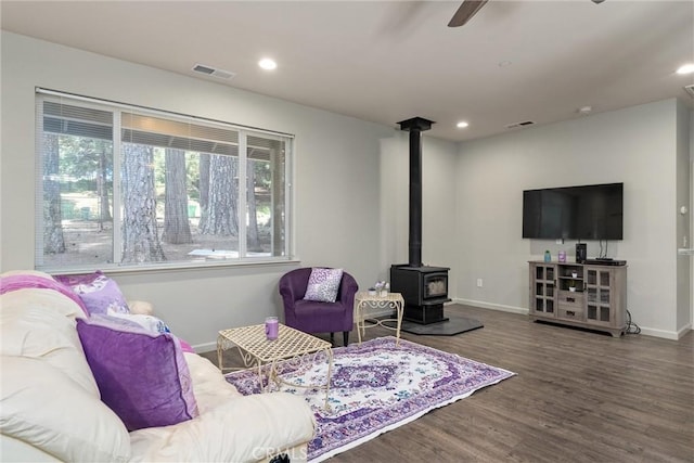 14868 Hickok Ct, Magalia, CA 95954 - living area with plenty of natural light, a wood stove, a ceiling fan, baseboards, and recessed lighting