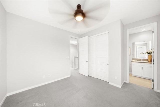149 Carmine, Irvine, CA 92618 - unfurnished bedroom featuring light carpet, baseboards, a closet, a sink, and a ceiling fan