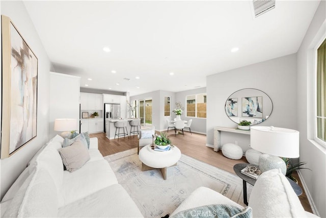 149 Carmine, Irvine, CA 92618 - living room featuring light wood-style flooring, recessed lighting, and baseboards