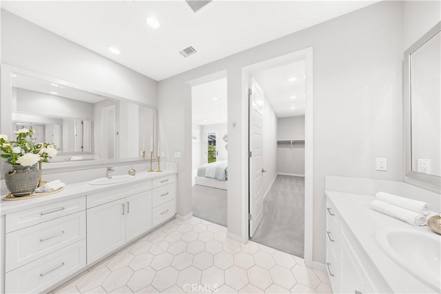 149 Carmine, Irvine, CA 92618 - ensuite bathroom featuring two vanities, recessed lighting, tile patterned floors, and baseboards
