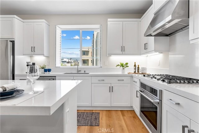 25 Splendor Way, Rancho Mission Viejo, CA 92694 - kitchen with stainless steel appliances, wall chimney range hood, a sink, and light countertops