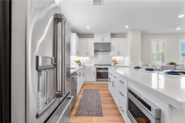 25 Splendor Way, Rancho Mission Viejo, CA 92694 - kitchen with appliances with stainless steel finishes, under cabinet range hood, light countertops, white cabinetry, and recessed lighting