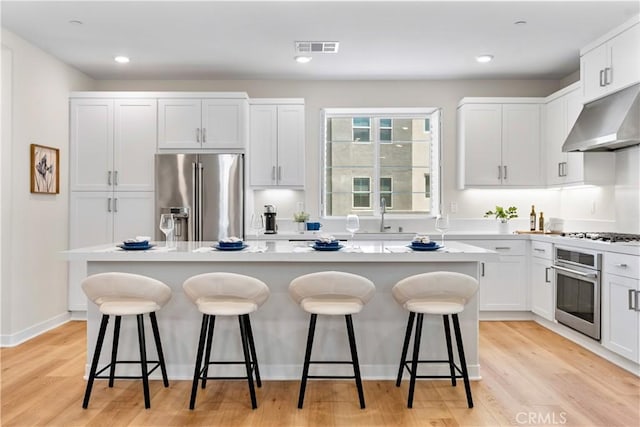 25 Splendor Way, Rancho Mission Viejo, CA 92694 - kitchen featuring appliances with stainless steel finishes, under cabinet range hood, a sink, a center island, and a kitchen breakfast bar