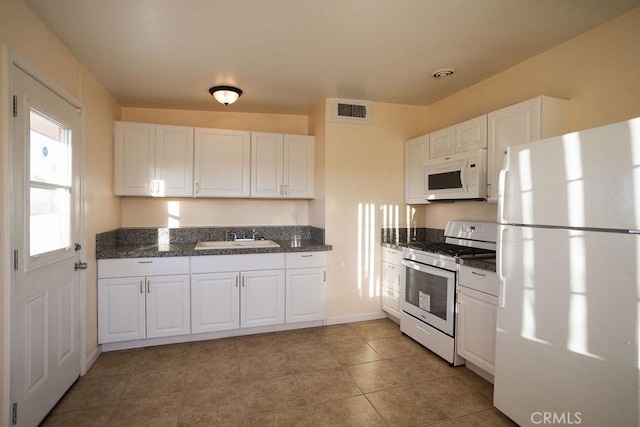 58382 Sunny Sands Dr, Yucca Valley, CA 92284 - kitchen featuring white appliances, white cabinets, a sink, and baseboards