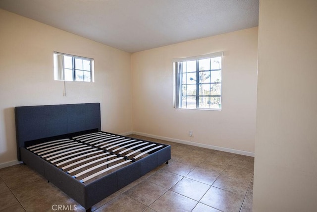 58382 Sunny Sands Dr, Yucca Valley, CA 92284 - unfurnished bedroom with baseboards and tile patterned floors
