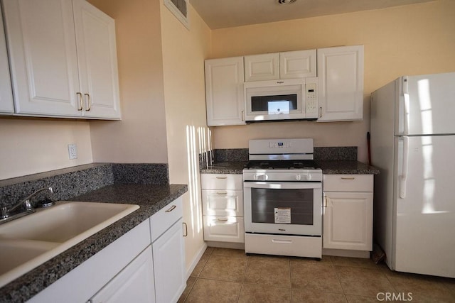 58382 Sunny Sands Dr, Yucca Valley, CA 92284 - kitchen featuring white appliances, white cabinetry, a sink, and dark countertops