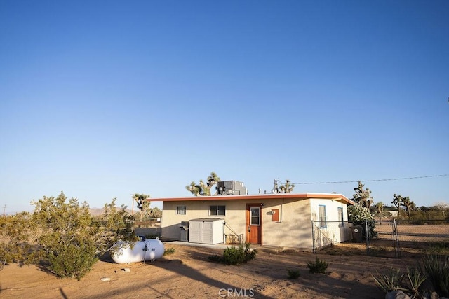 58382 Sunny Sands Dr, Yucca Valley, CA 92284 - back of house featuring a gate and stucco siding