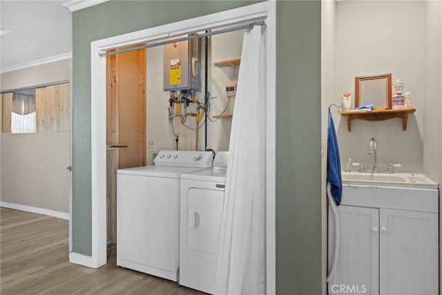 4436 County Road M 1/2, Orland, CA 95963 - laundry area featuring water heater, wood finished floors, washing machine and clothes dryer, ornamental molding, and baseboards
