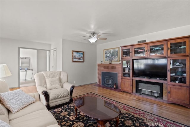 4436 County Road M 1/2, Orland, CA 95963 - living room featuring light wood-style floors, a ceiling fan, and a fireplace