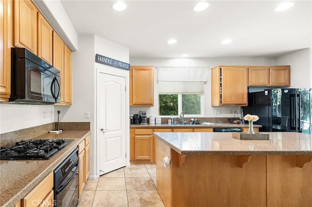 29778 Salmon St, Menifee, CA 92584 - kitchen with black appliances, recessed lighting, a kitchen breakfast bar, a sink, and stone counters