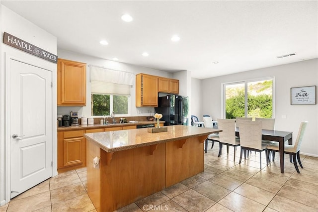 29778 Salmon St, Menifee, CA 92584 - kitchen with freestanding refrigerator, a kitchen island, a sink, recessed lighting, and a breakfast bar area