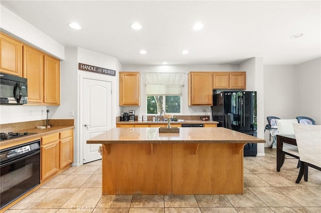 29778 Salmon St, Menifee, CA 92584 - kitchen with black appliances, a center island, recessed lighting, stone countertops, and a breakfast bar area