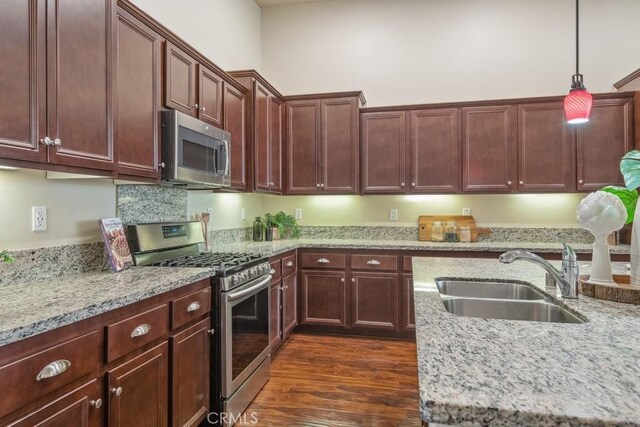 25863 Prospector Ct, Menifee, CA 92584 - kitchen with appliances with stainless steel finishes, a sink, hanging light fixtures, and light stone countertops