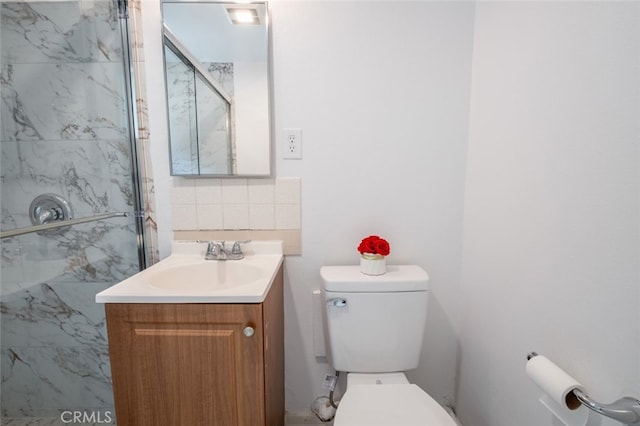 39026 11th St W, Palmdale, CA 93551 - bathroom featuring toilet, a marble finish shower, vanity, and backsplash