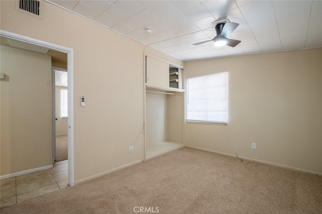 39026 11th St W, Palmdale, CA 93551 - unfurnished bedroom with light colored carpet, a closet, ceiling fan, and baseboards