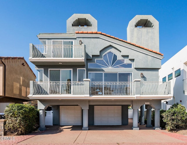 5331 Wavecrest Way, Oxnard, CA 93035 - view of front facade featuring a balcony, a garage, stucco siding, and driveway