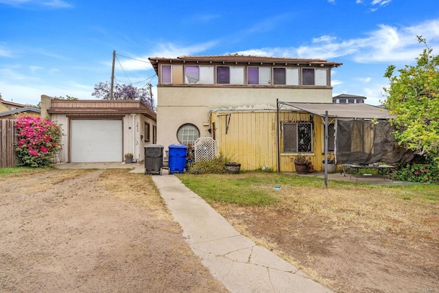 301820 Nimitz Blvd, San Diego, CA 92106 - view of front of home featuring driveway, stucco siding, a trampoline, and an attached garage
