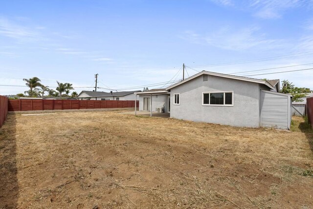 450 Dichter St, El Cajon, CA 92019 - back of property featuring stucco siding and a fenced backyard