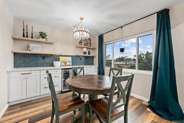 169 Theresa Way, Chula Vista, CA 91911 - dining area with beverage cooler, a bar, wood finished floors, a chandelier, and baseboards