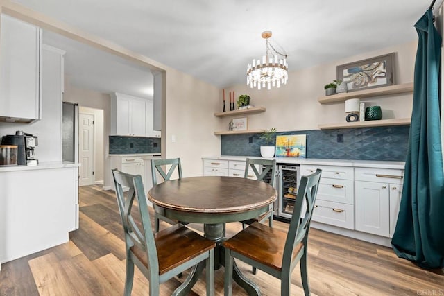 169 Theresa Way, Chula Vista, CA 91911 - dining room with wine cooler, wood finished floors, and a chandelier
