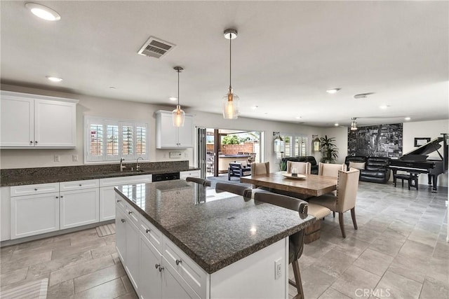 15040 Capstone St, Fontana, CA 92336 - kitchen featuring recessed lighting, healthy amount of natural light, white cabinetry, and a sink