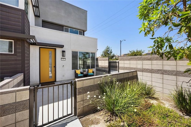 3720 S Allston Paseo Unit 7, Ontario, CA 91761 - doorway to property featuring a gate, a balcony, and stucco siding