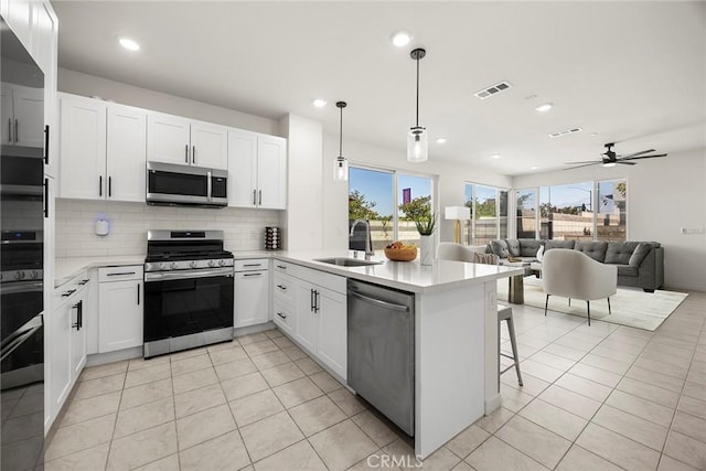 3720 S Allston Paseo Unit 7, Ontario, CA 91761 - kitchen featuring stainless steel appliances, a sink, tasteful backsplash, light countertops, and recessed lighting