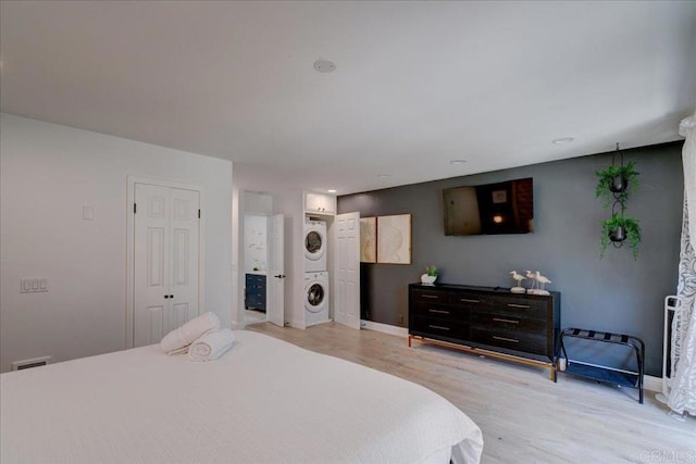 190 Del Mar Shores Ter Unit 24, Solana Beach, CA 92075 - bedroom with stacked washer / dryer, wood finished floors, and baseboards