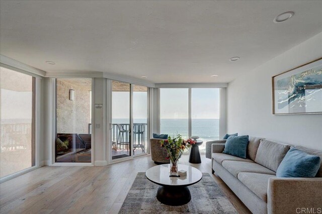 190 Del Mar Shores Ter Unit 24, Solana Beach, CA 92075 - living room with floor to ceiling windows, wood finished floors, and a water view