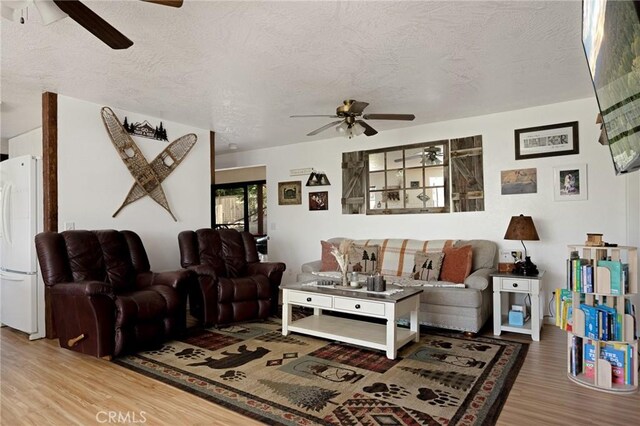 26249 Cedar Ln, Twin Peaks, CA 92391 - living room featuring a ceiling fan, wood finished floors, and a textured ceiling