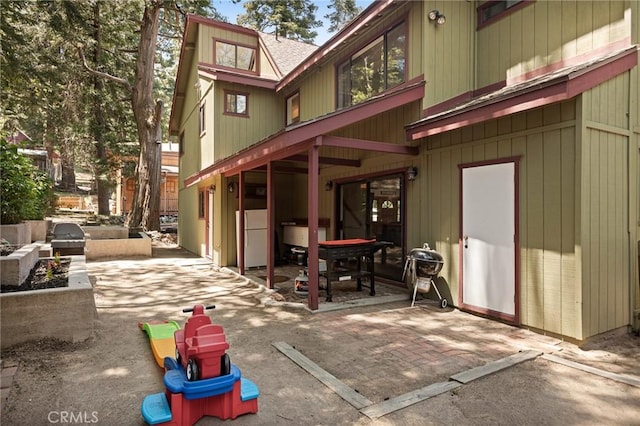 26249 Cedar Ln, Twin Peaks, CA 92391 - back of house with a patio area and roof with shingles