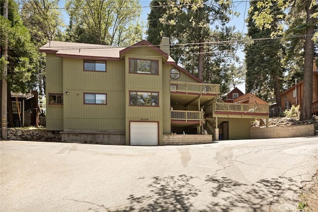 26249 Cedar Ln, Twin Peaks, CA 92391 - back of house featuring a chimney, a garage, a deck, and stairway