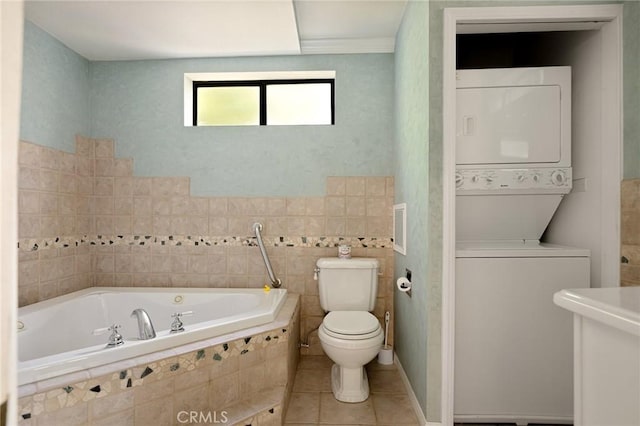 26249 Cedar Ln, Twin Peaks, CA 92391 - full bath with stacked washing machine and dryer, a bath, toilet, tile walls, and tile patterned floors