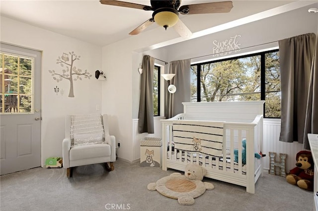 26249 Cedar Ln, Twin Peaks, CA 92391 - carpeted bedroom with a nursery area, multiple windows, and ceiling fan