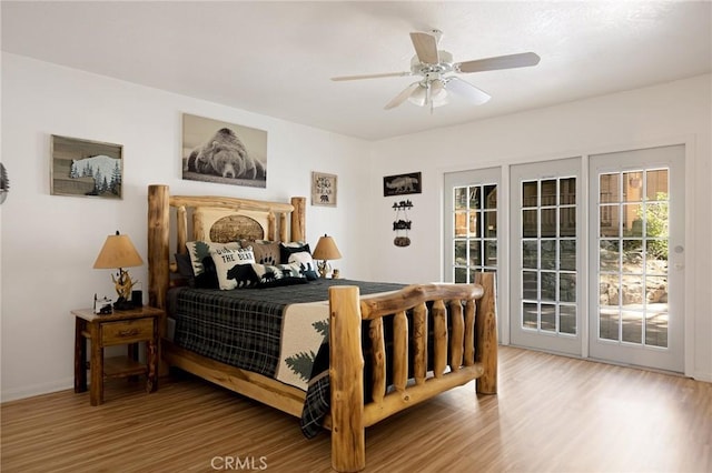26249 Cedar Ln, Twin Peaks, CA 92391 - bedroom with access to exterior, wood finished floors, a ceiling fan, and baseboards