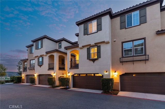 22124 Barrington Way, Saugus, CA 91350 - view of front of house with stucco siding, a garage, a tile roof, and a balcony