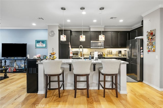 22124 Barrington Way, Saugus, CA 91350 - kitchen with stainless steel appliances, light wood finished floors, a breakfast bar, light stone countertops, and ornamental molding