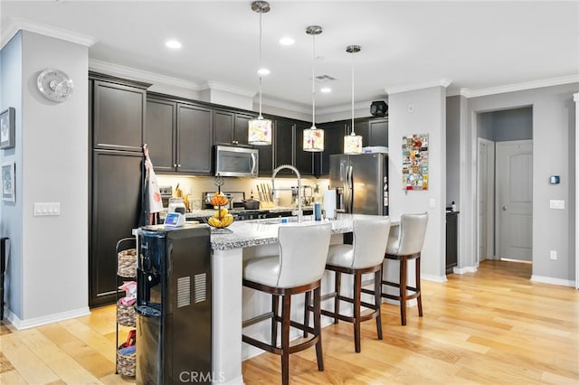 22124 Barrington Way, Saugus, CA 91350 - kitchen featuring stainless steel appliances, light wood-style floors, a breakfast bar, recessed lighting, and pendant lighting