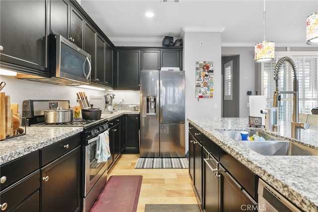 22124 Barrington Way, Saugus, CA 91350 - kitchen featuring stainless steel appliances, a sink, crown molding, light stone counters, and pendant lighting