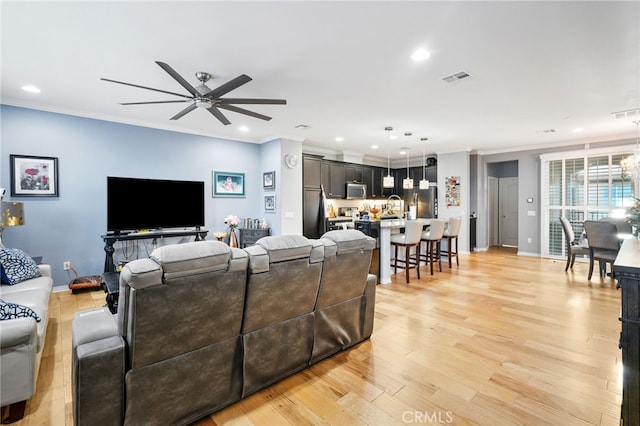 22124 Barrington Way, Saugus, CA 91350 - living room featuring ceiling fan, ornamental molding, light wood-style floors, recessed lighting, and baseboards