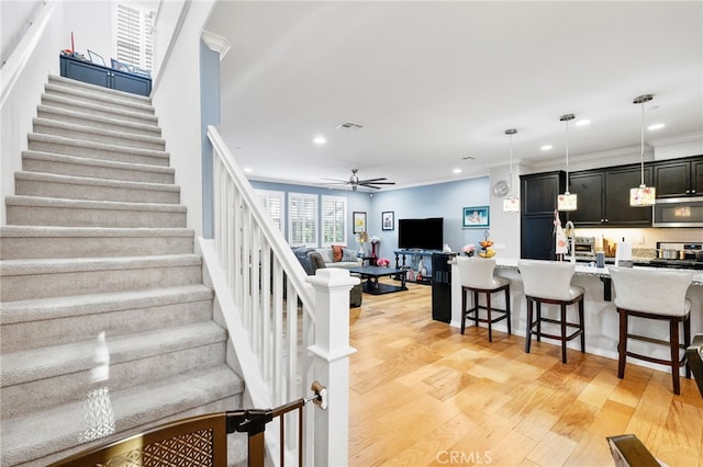 22124 Barrington Way, Saugus, CA 91350 - stairway featuring wood finished floors, recessed lighting, a ceiling fan, and crown molding