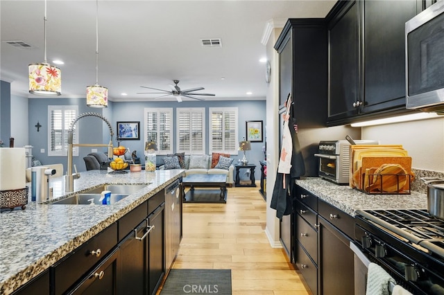 22124 Barrington Way, Saugus, CA 91350 - kitchen featuring stainless steel appliances, a sink, open floor plan, light wood-type flooring, and recessed lighting